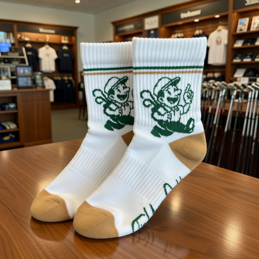 White socks with green graphics on a wooden table in a golf pro shop